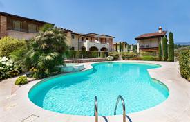 Two-bedroom apartment with a garden in a residence with a swimming pool, near the lake, Manerba del Garda, Italy. Price on request