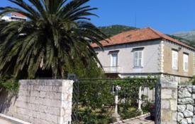 Two-level villa with a garden, a garage and a pier on the first line of the sea near Dubrovnik, Dalmatia, Croatia. Price on request